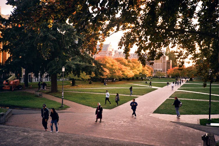 People striding across a campus.