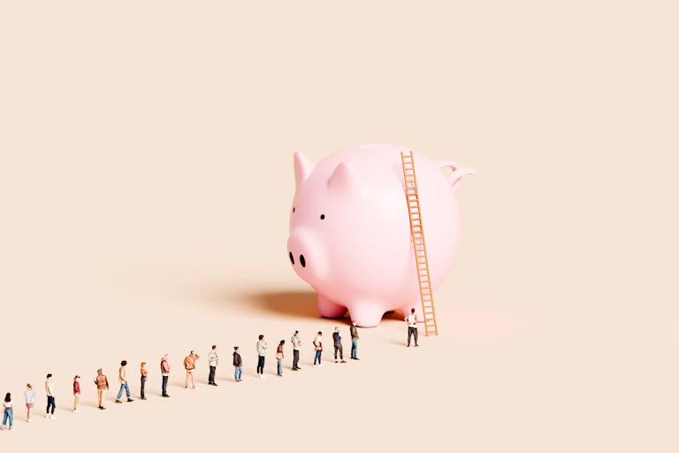 A ladder leans against a massive piggy bank. A line of people stand waiting to climb.
