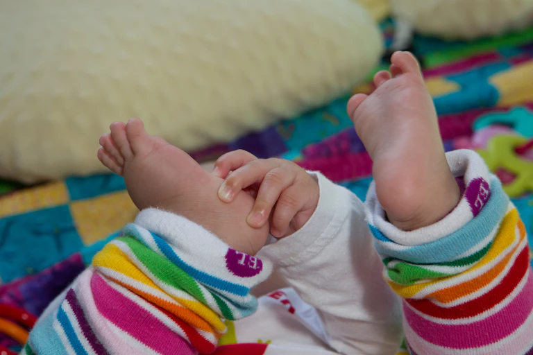 Baby with its feet in the air.