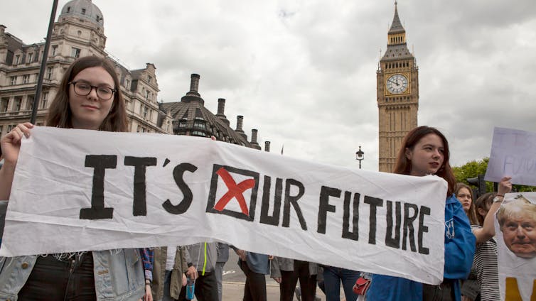 UK to decrease balloting age to 16 – a once-in-a-generation alternative to protected the longer term well being of British democracy 1 Two young people holding up a banner reading 'it's our future'.