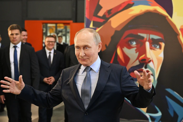 Vladimir Putin gestures with his arms wide as he visits the Magnitogorsk Iron and Steel Works in the Urals, July 16 2025.
