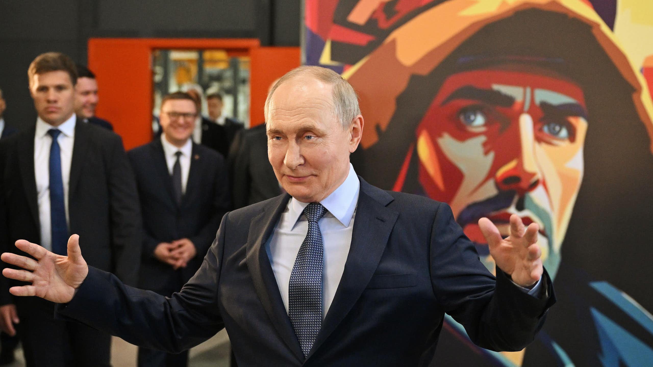 Vladimir Putin gestures with his arms wide as he visits the Magnitogorsk Iron and Steel Works in the Urals, July 16 2025.