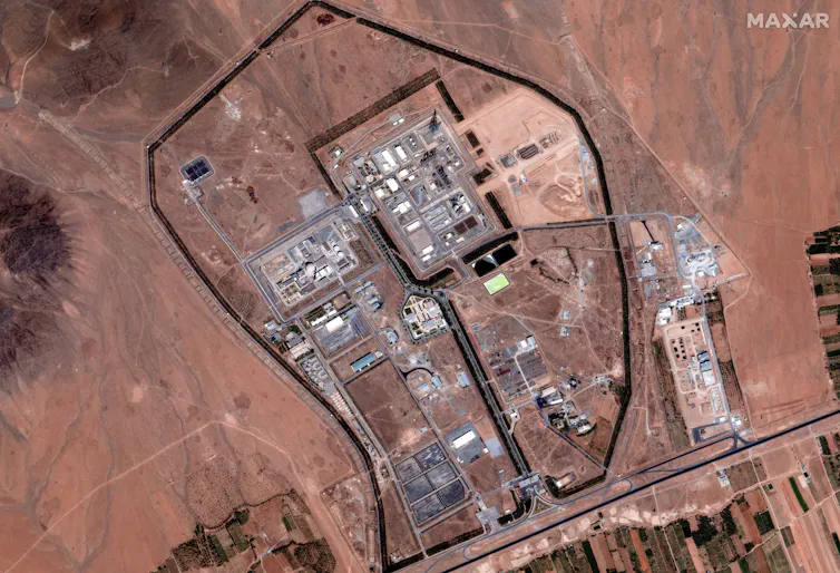 a satellite view of a complex of buidlings on a desert landscape