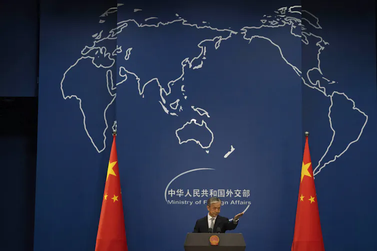 A man talks at a lectern.