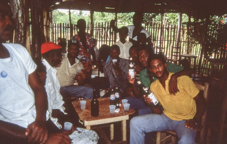 Group of friends at a social gathering, posing for a camera
