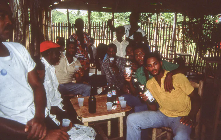 Group of friends at a social gathering, posing for a camera