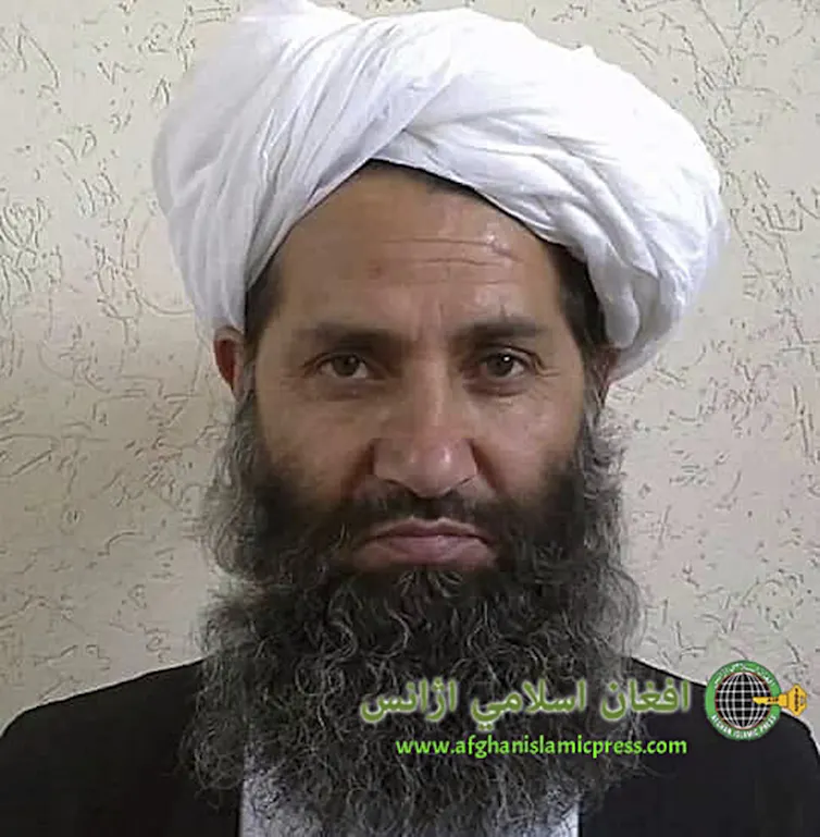 Bearded Haibatullah Akhundzada wearing a white head scarf.