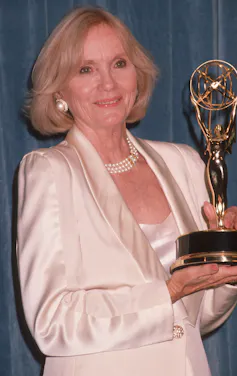 Saint holds her Emmy.