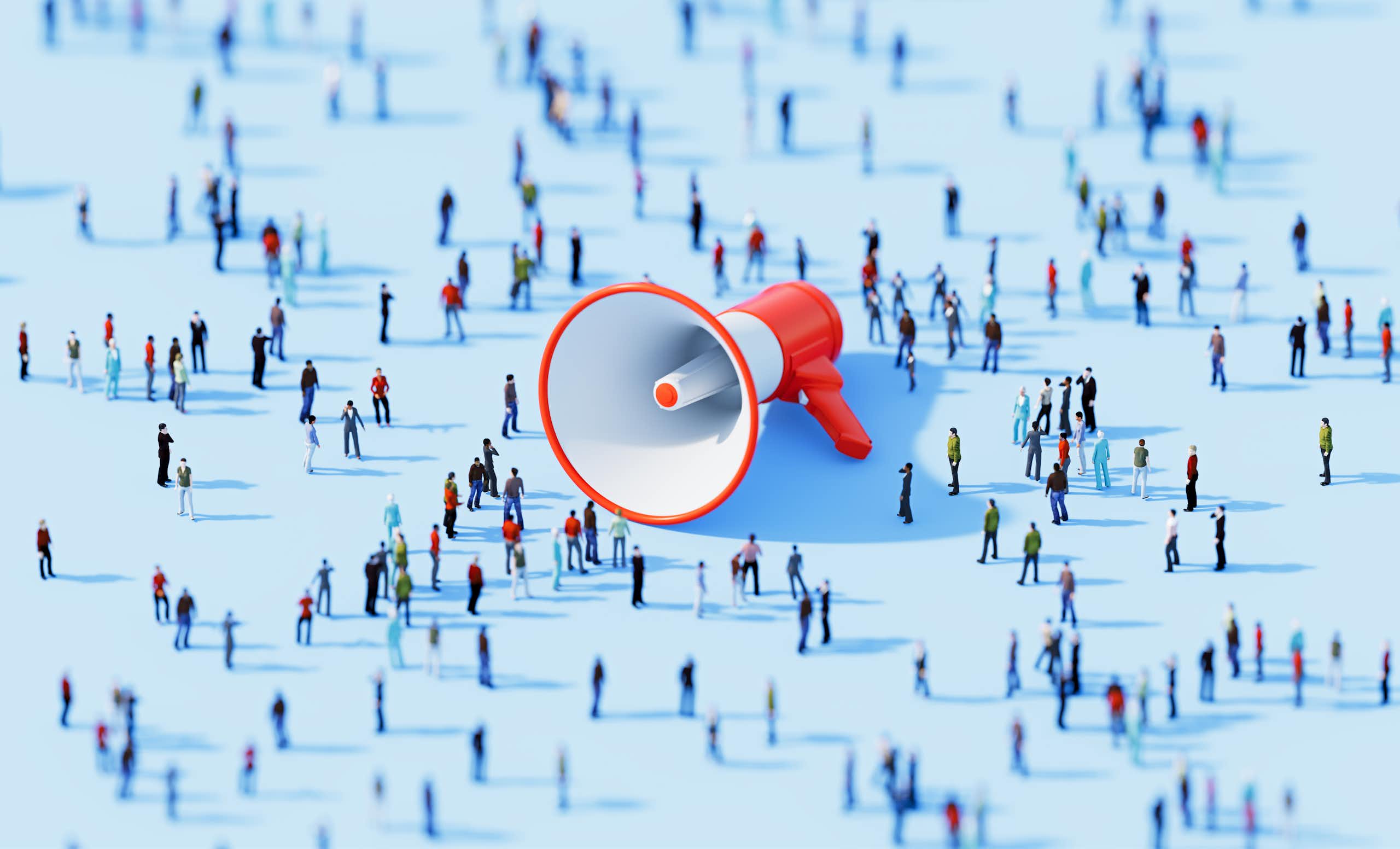 A megaphone lying on its side, surrounded by lots of people.