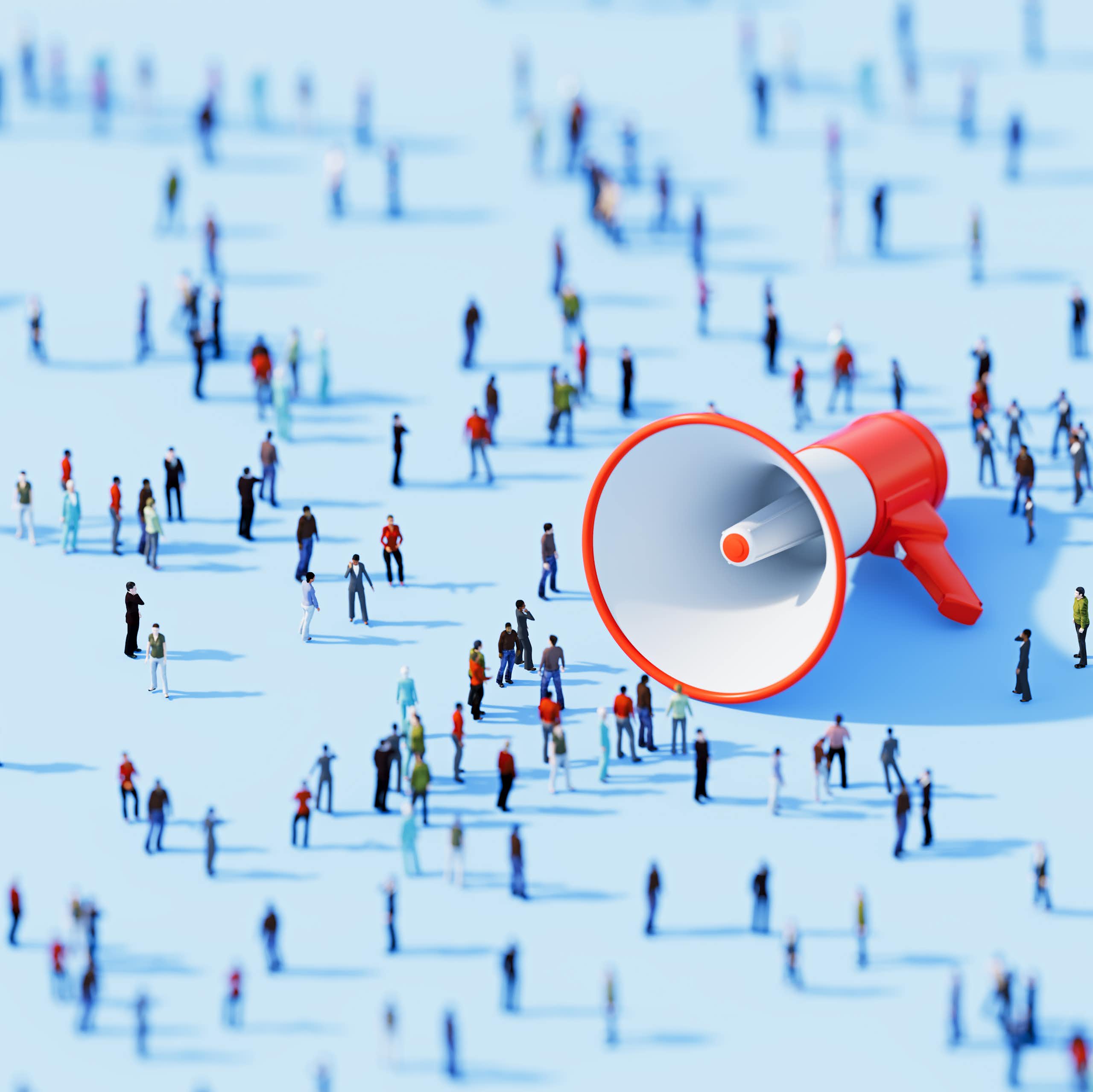 A megaphone lying on its side, surrounded by lots of people.
