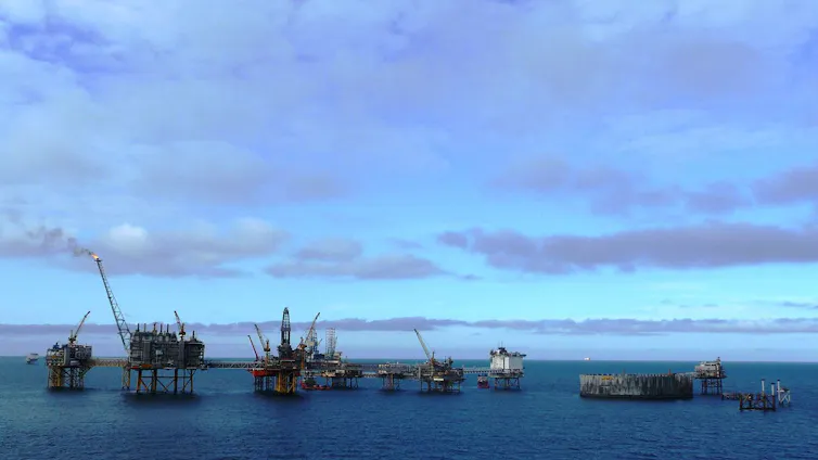 Several structures standing in the sea.