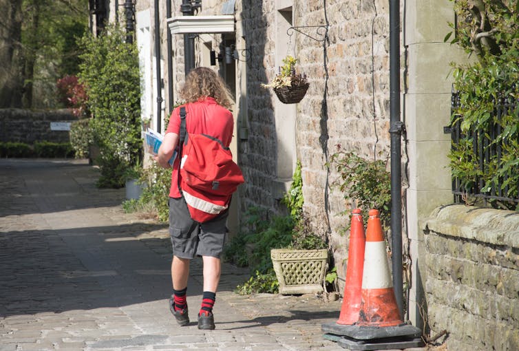 female postal worker doing her round on foot.