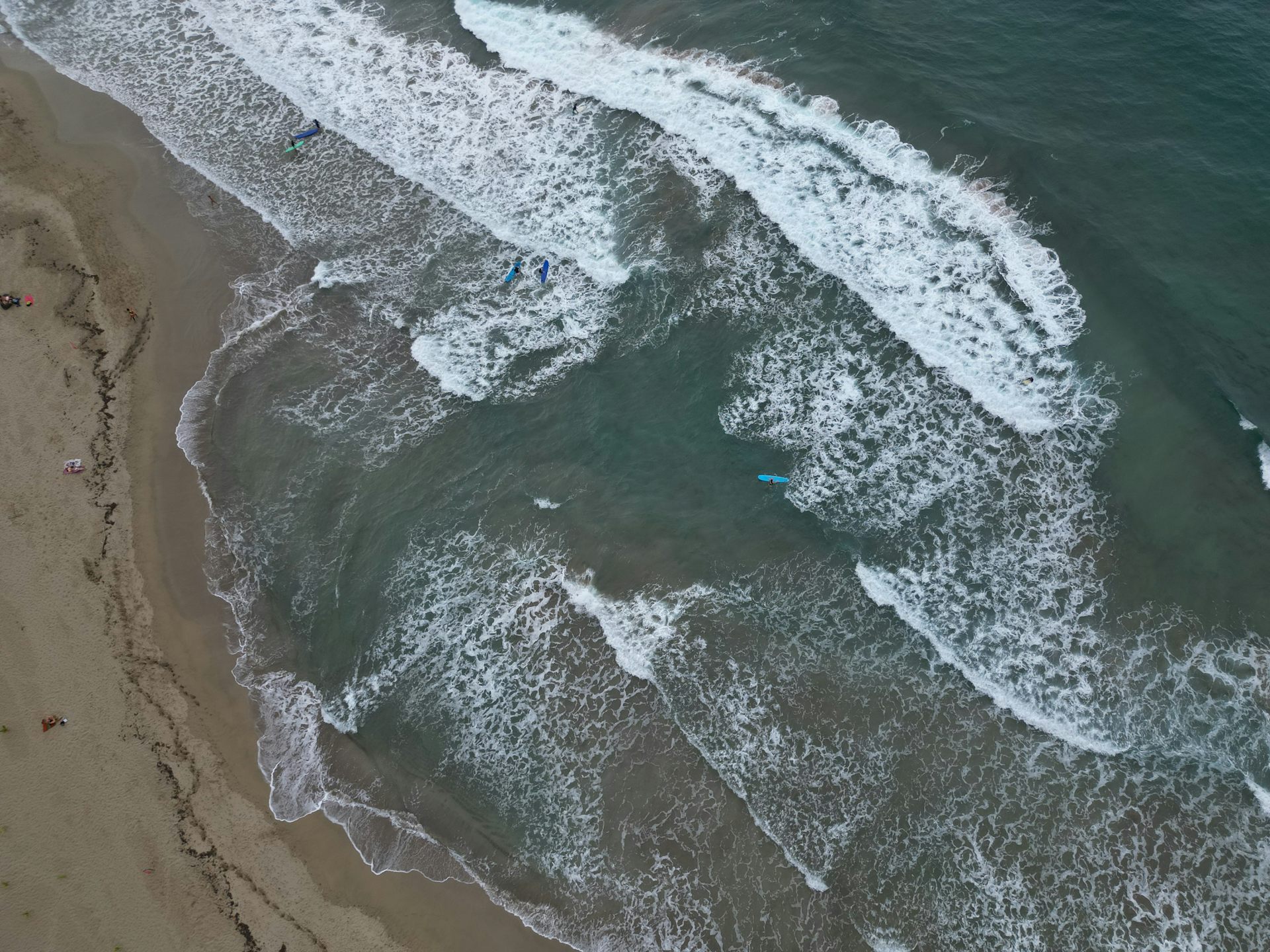 An aerial view of a beach with a rip current. 