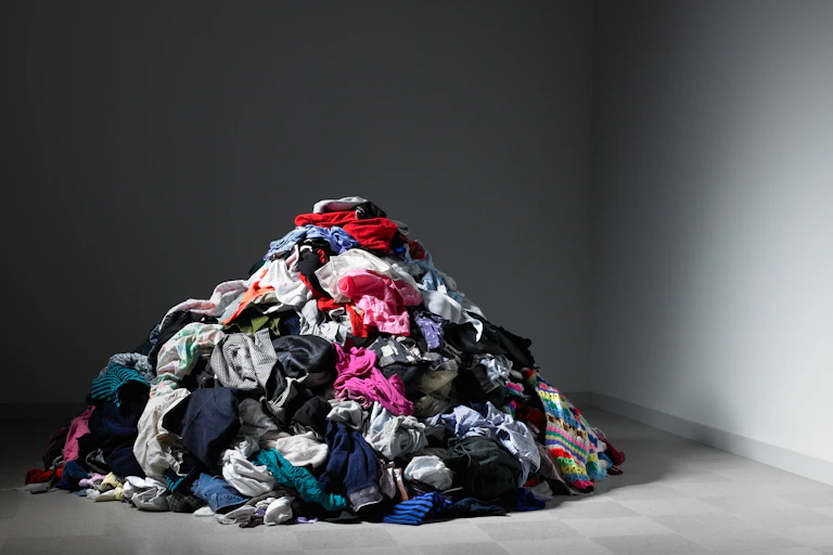 pile of clothes, dark room.