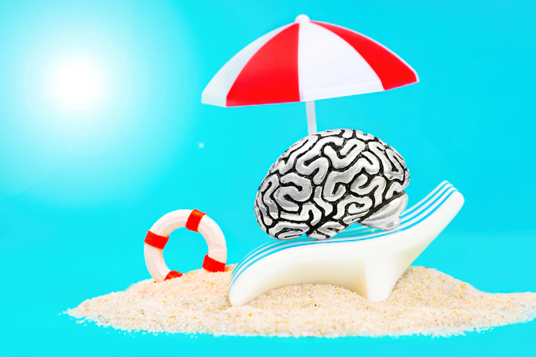 Dibujo de cerebro en una tumbona en la playa