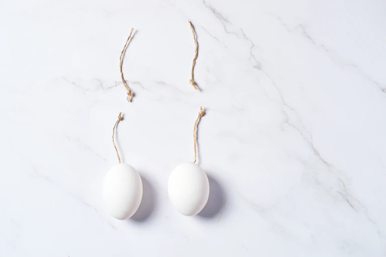 symbolic threads cut to represent vasectomy on white background