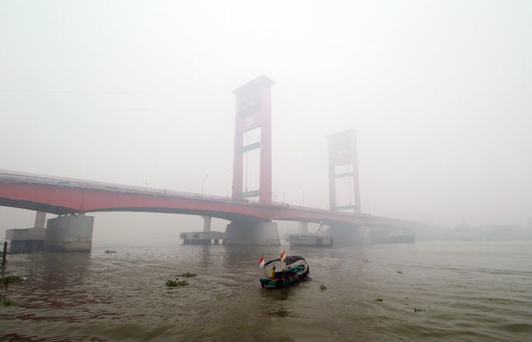 A large bridge engulfed by smoke.
