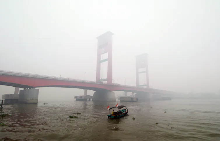 A large bridge engulfed by smoke.