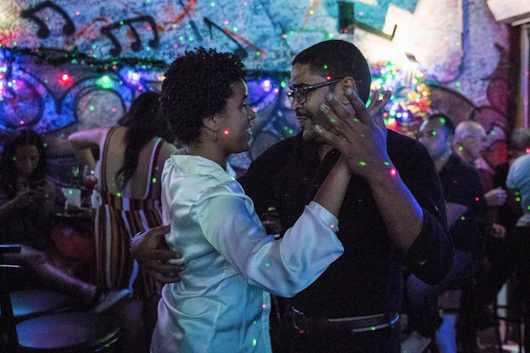 Man and woman seen dancing closely in nightclub