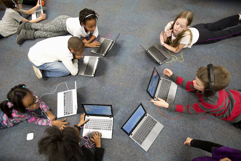 Group of 4th grade students working on laptop computers.