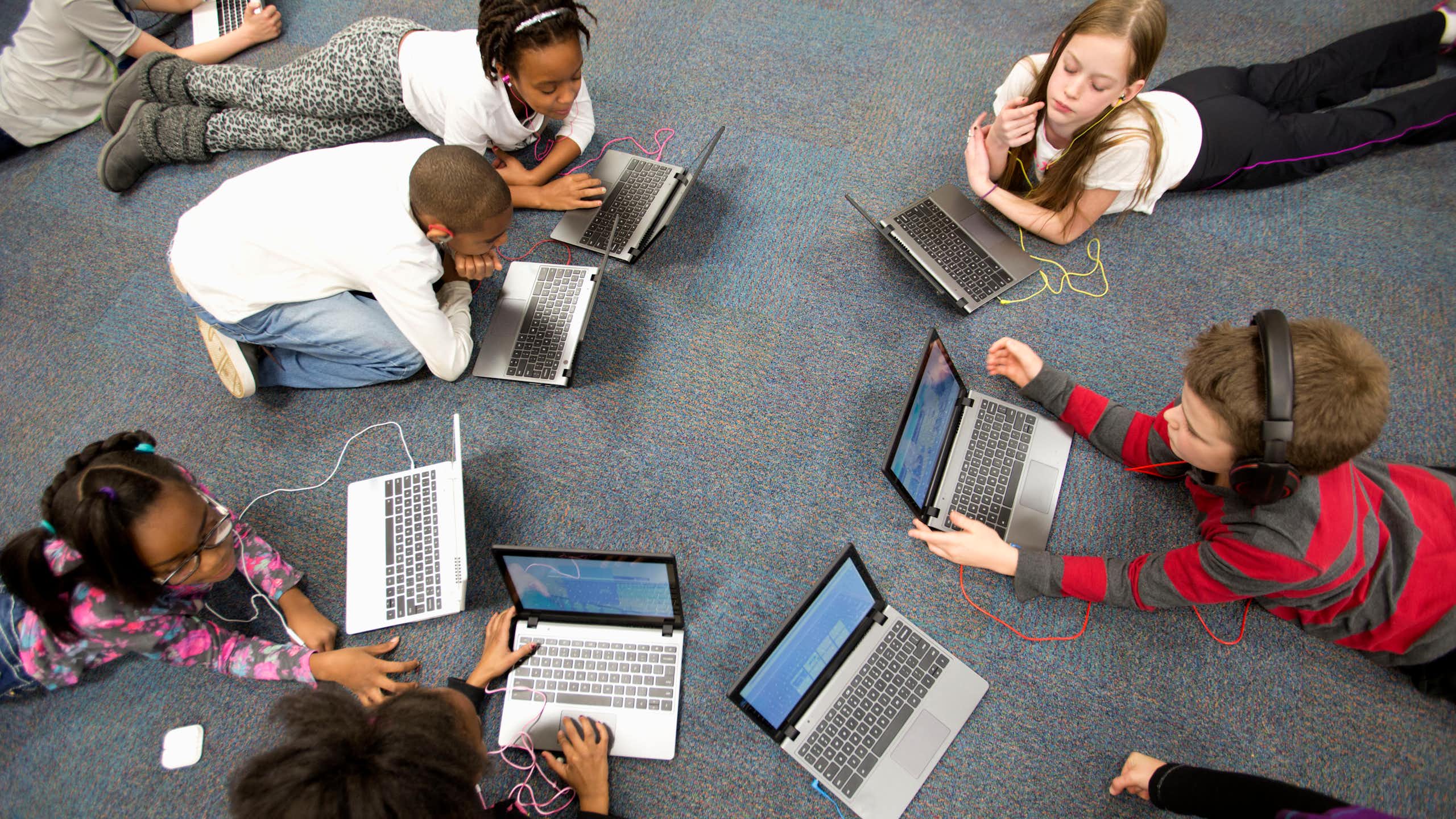 Group of 4th grade students working on laptop computers.