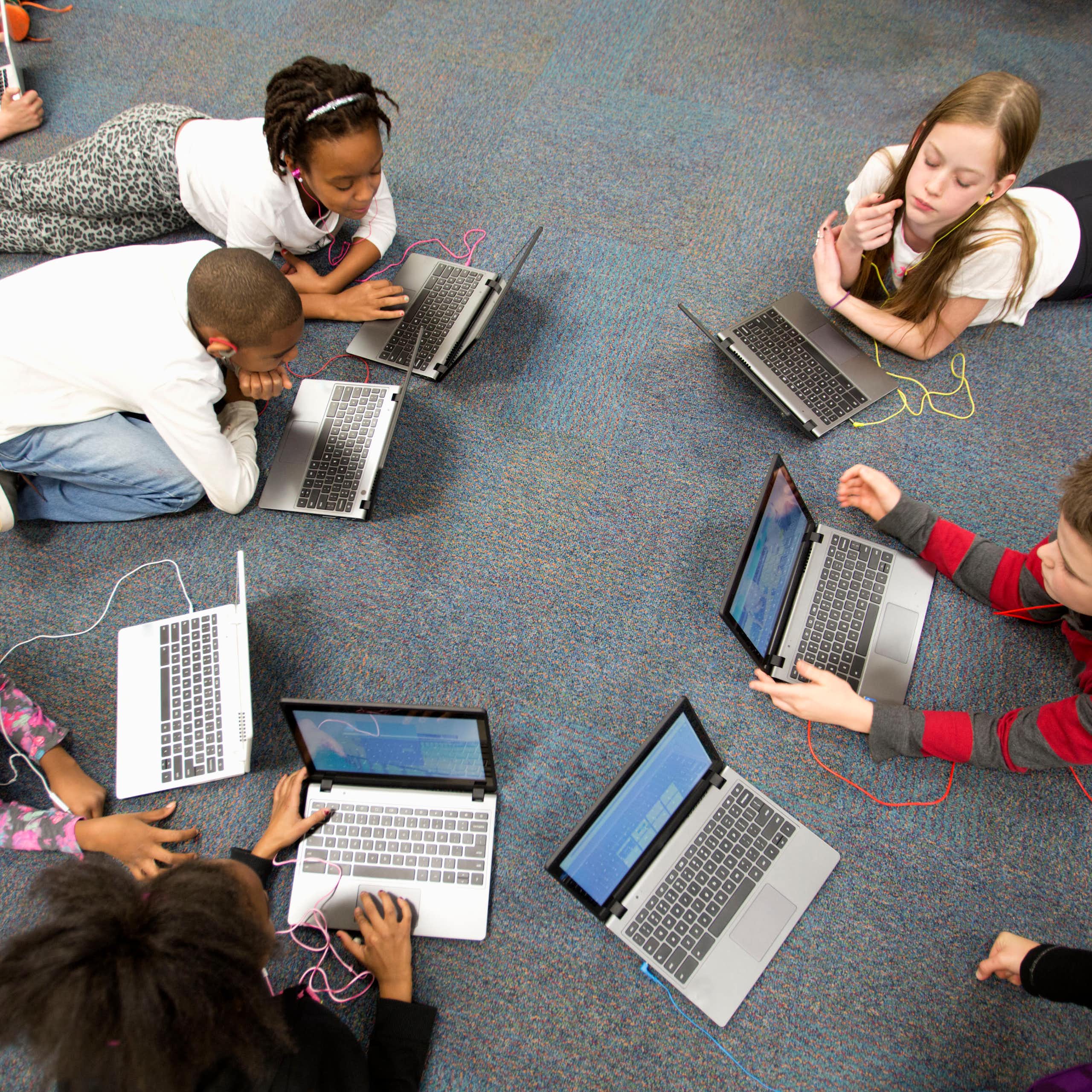 Group of 4th grade students working on laptop computers.