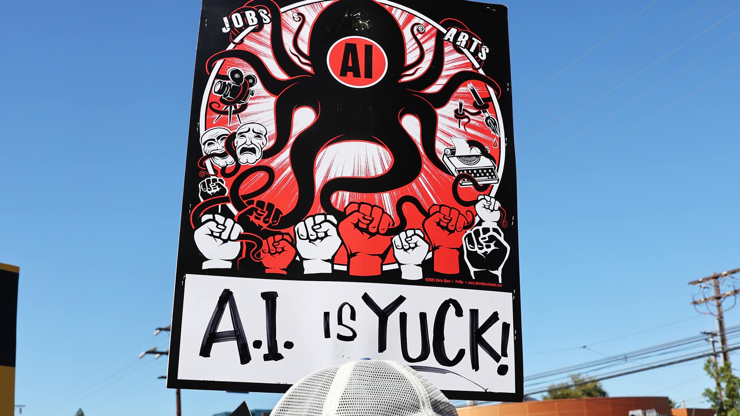 a protest sign depicting an octopus labelled AI