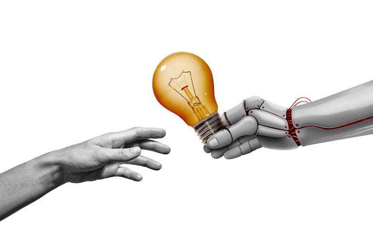 An illustration shows a robotic hand extending a light bulb to a human.
