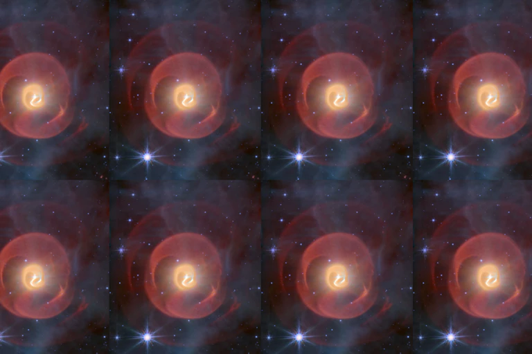 Three shells of dust, looking like coiled snakes, the middle one yellow and the outer ones red, seen against a background of blue stars. This is a false-colour image displaying infrared data from James Webb's MIRI camera.