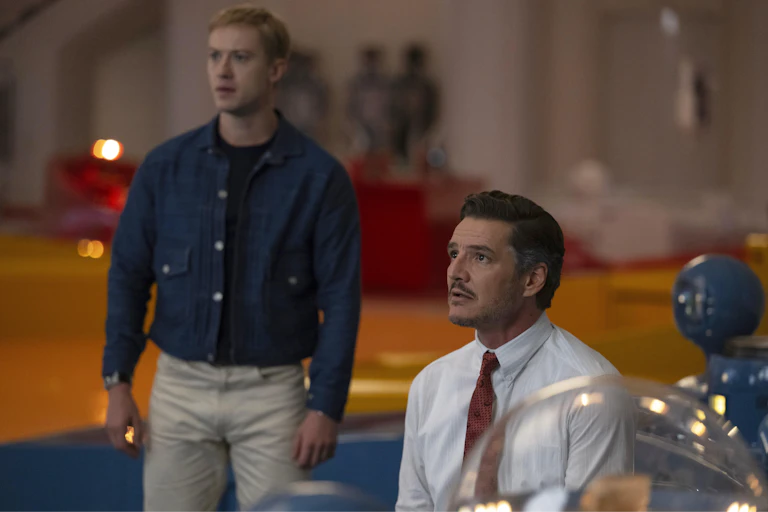 One man standing and another sitting in a white shirt and red tie, with a humanoid type figure next to him.