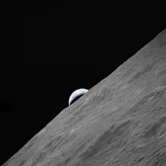 Surface of the moon and a small part of the Earth above it