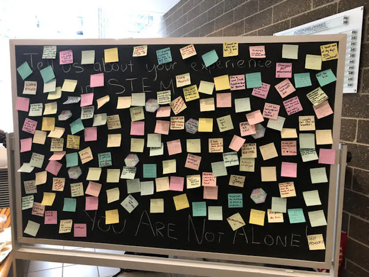 A chalkboard covered in post it notes.