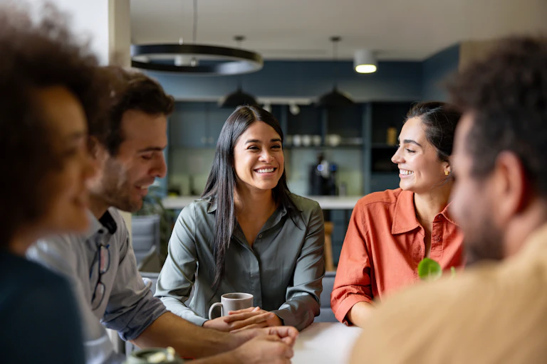 A woman smiling in a meeting at the office