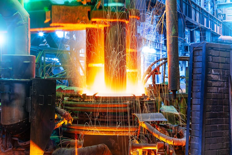 Electric arc furnace with sparks seen flying