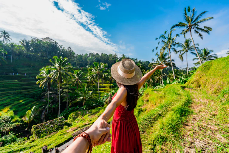 a young woman posing for a photo at a rice terrace selfie park in Bali