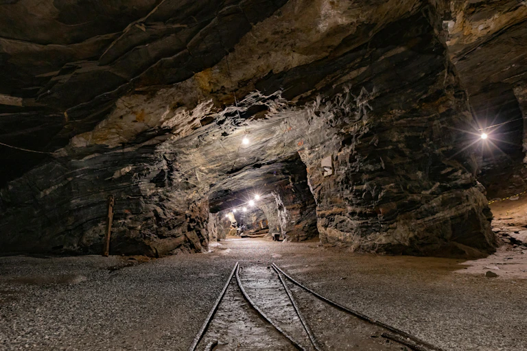 Underground tunnel with rail tracks and lights