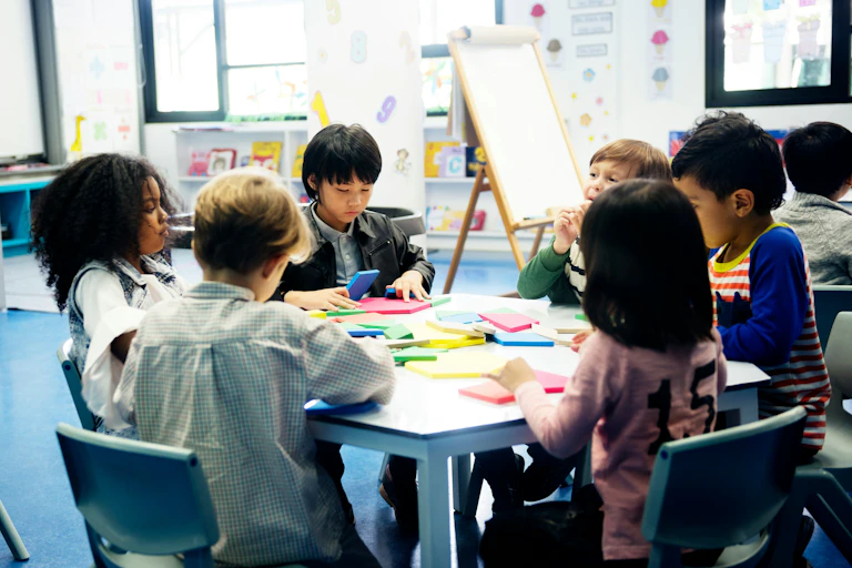 A group of children working at a table in a classroom