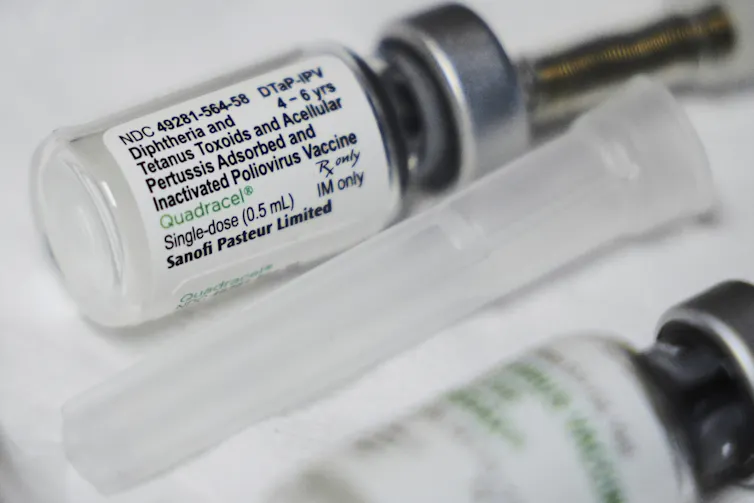 Close-up photo of a vial of combined diphtheria, tetanus, whooping cough and polio pediatric vaccine
