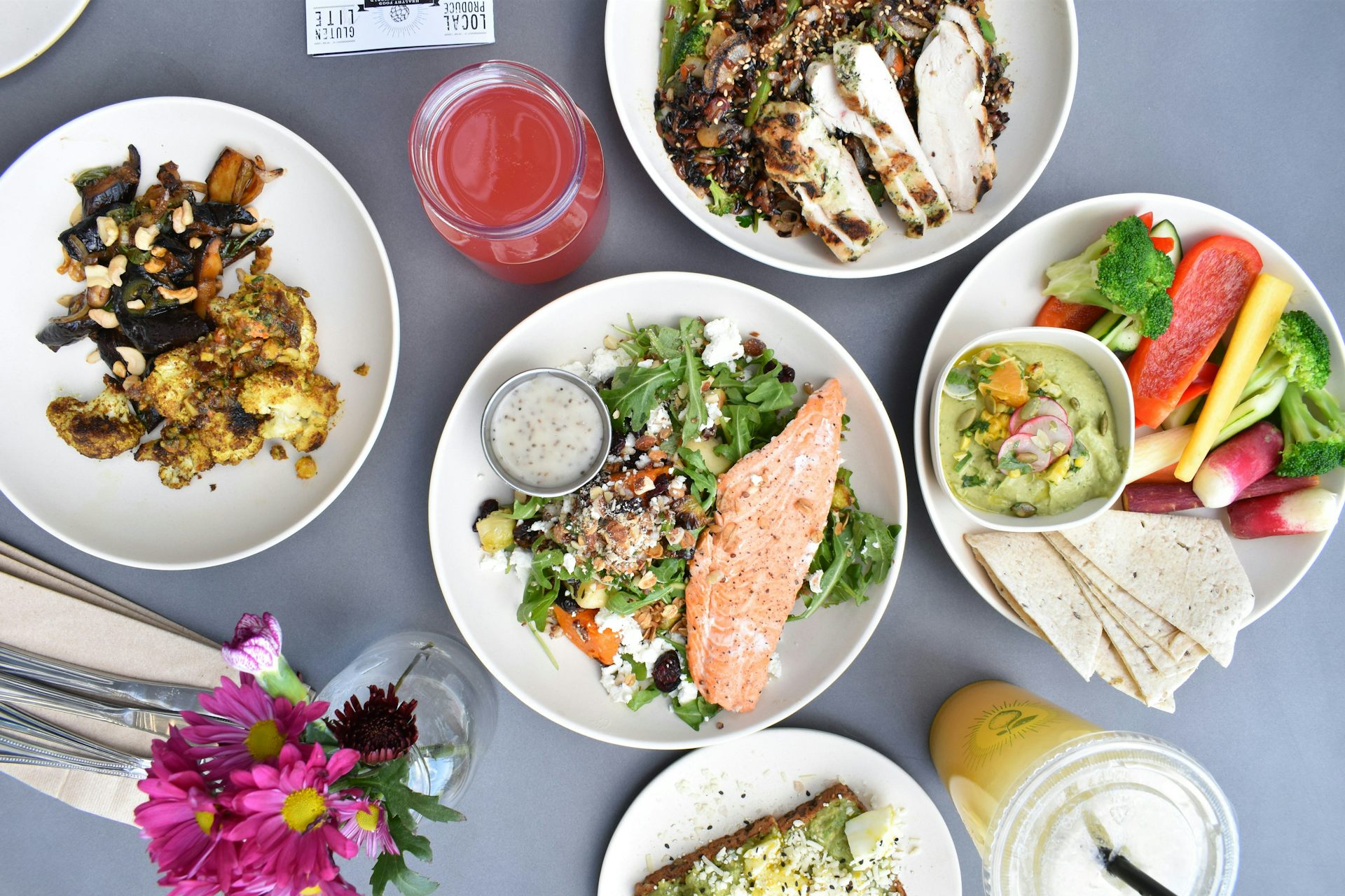 Plates of food including fish, chicken and nuts