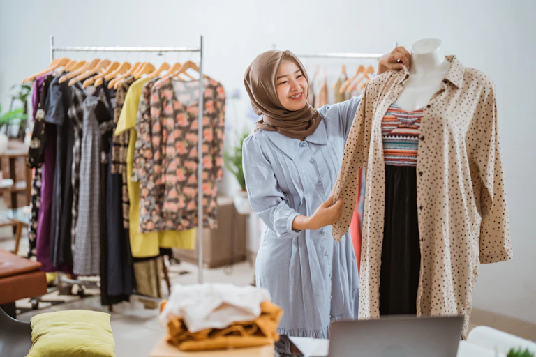 Woman sorts clothes in a small business