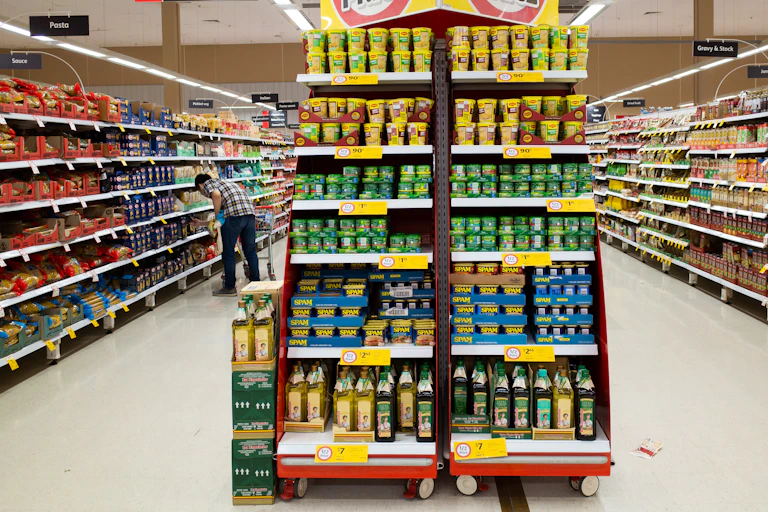 Melbourne, VIC the shelves with a variety food products in a supermarket.