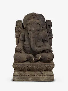 Ganesha made in Java from volcanic stone featuring skulls.