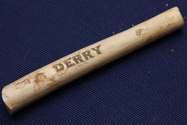 Artifact that looks like smooth stick with engraved with the word 'Derry'