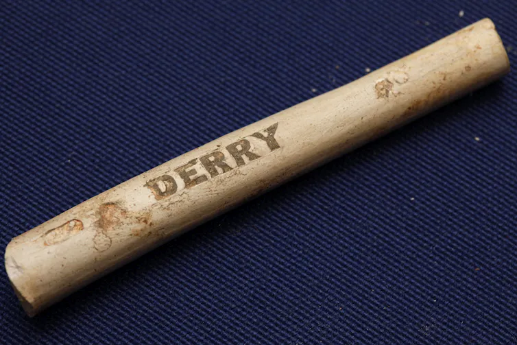 Artifact that looks like smooth stick with engraved with the word 'Derry'