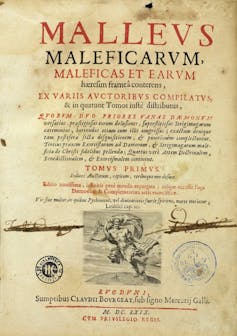 A yellowed title page from a manuscript, with print in black and red ink.
