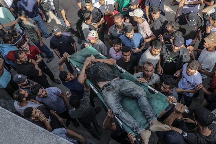 Will the newest diplomatic strikes to finish the conflict in Gaza paintings? 2 Palestinians carry the body of a young man killed by Israeli gunfire at an aid distribution point.