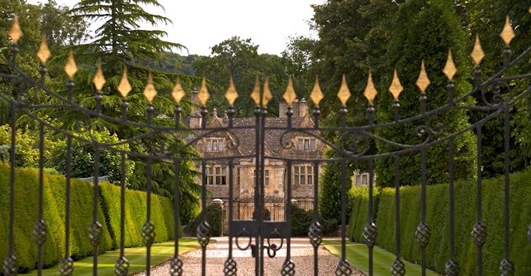 exterior shot of a gated mansion in the uk countryside