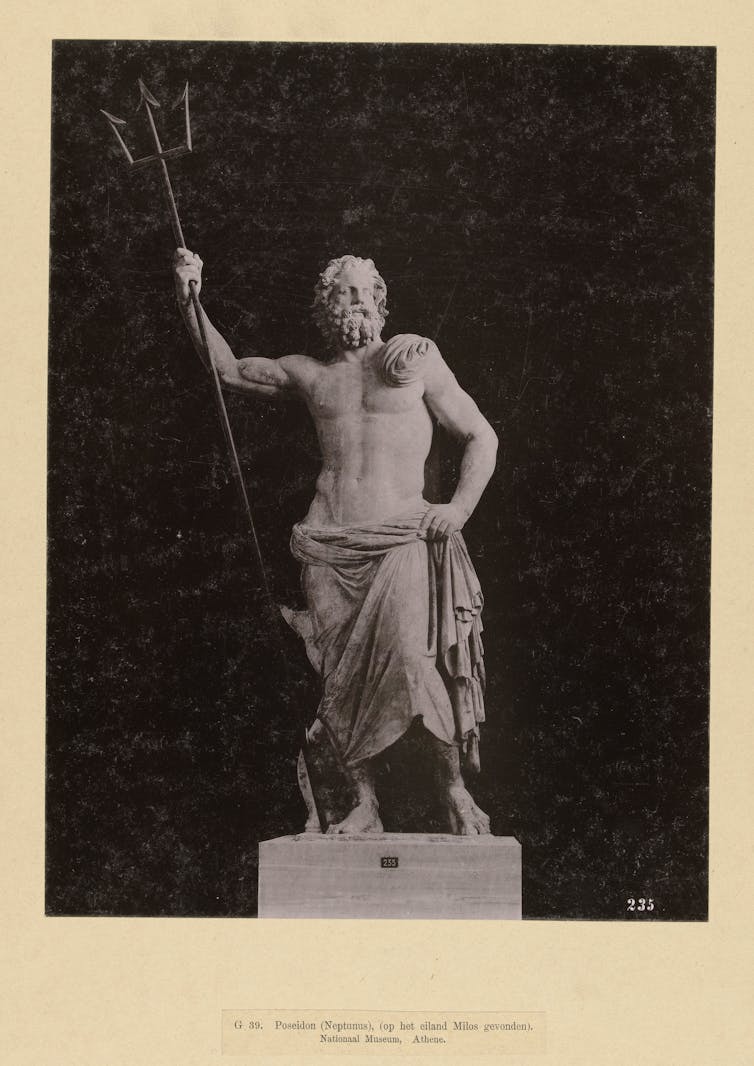 Statue of a man holding a trident.