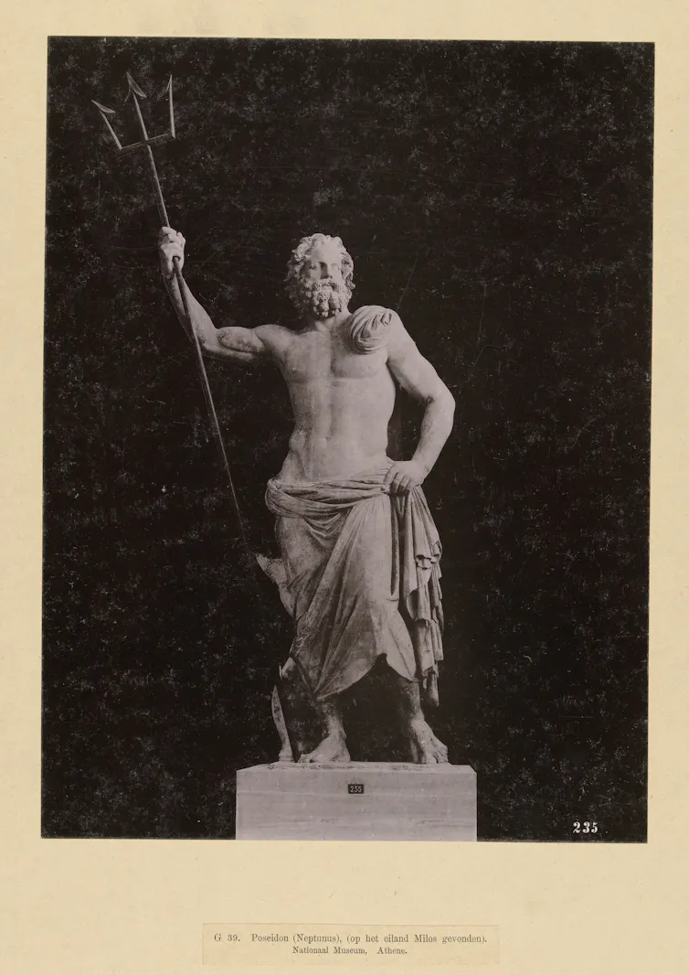 Statue of a man holding a trident.