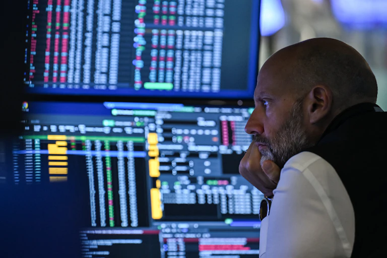 A trader works at his desk on the floor of the New York Stock Exchange.